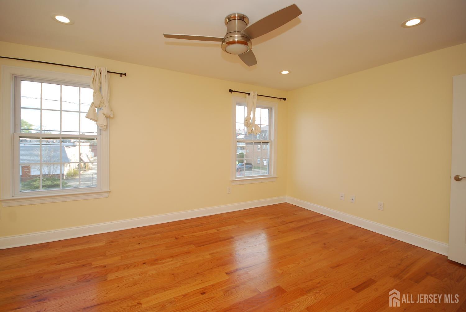 32 Cinder Road, Unit 3 Edison, NJ 08820 - Photo 30 of 34 an empty room with wooden floor and windows