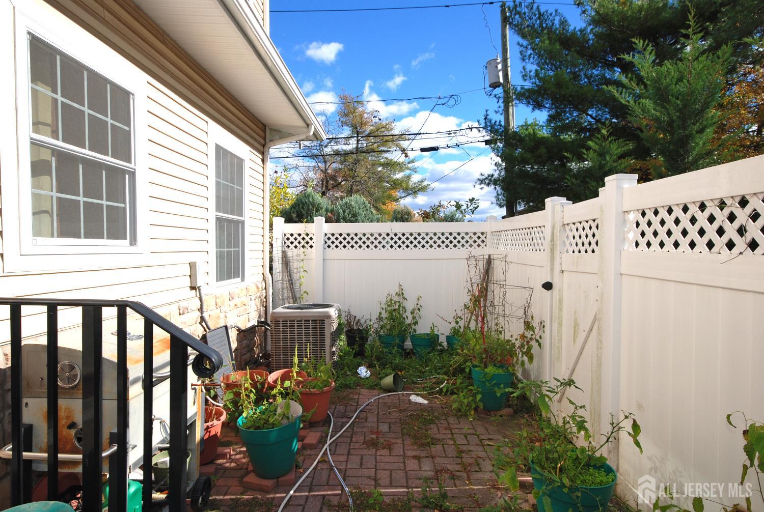 32 Cinder Road, Unit 3 Edison, NJ 08820 - Photo 34 of 34 a view of a chair and table in the backyard