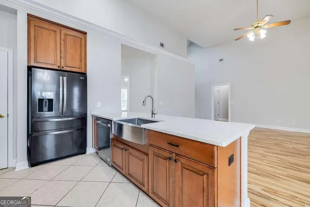 a kitchen with stainless steel appliances a refrigerator and a sink