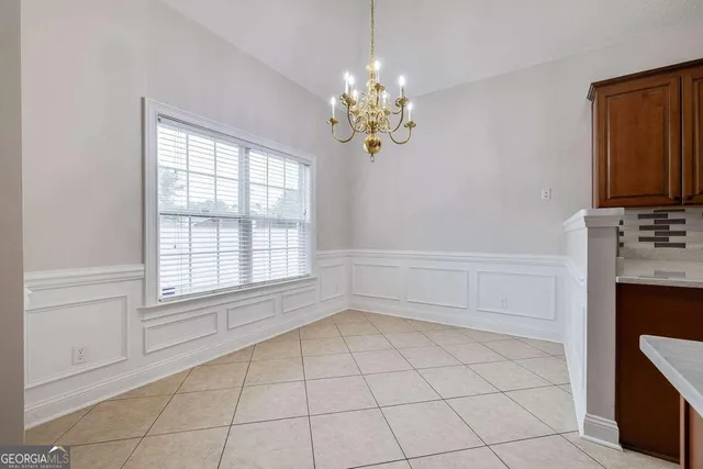 a kitchen with a refrigerator and microwave