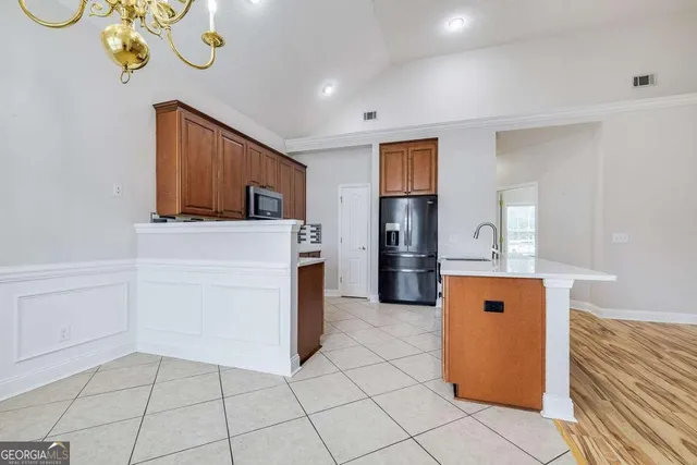 a kitchen with stainless steel appliances granite countertop a refrigerator a sink and dishwasher
