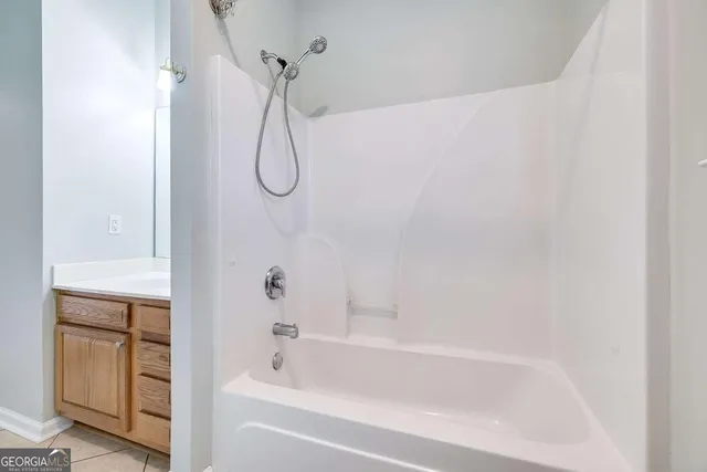 an empty room with wooden floor a exposed radiator and a window
