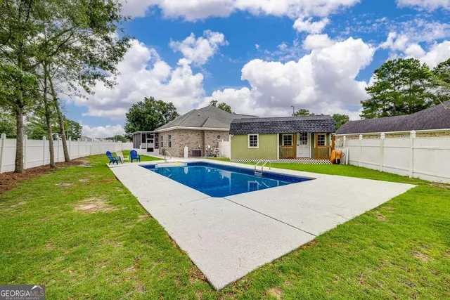a swimming pool with outdoor seating and yard