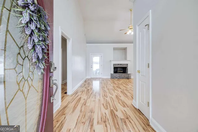 a view of entryway with wooden floor and front door