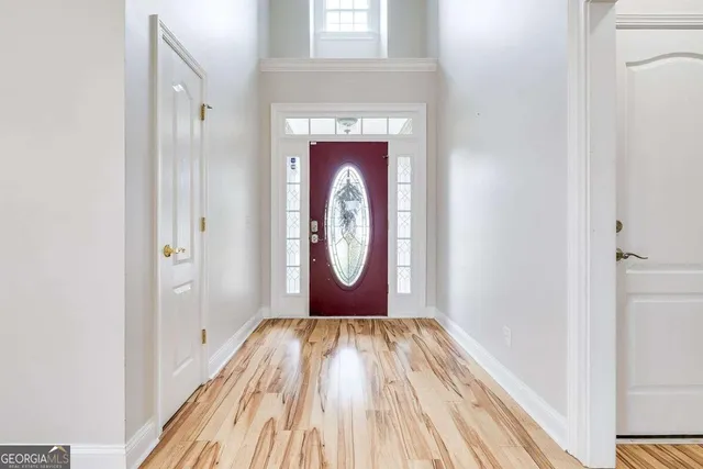a view of a hallway with wooden floor