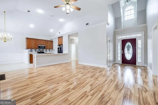 a view of a kitchen with a microwave and wooden floor