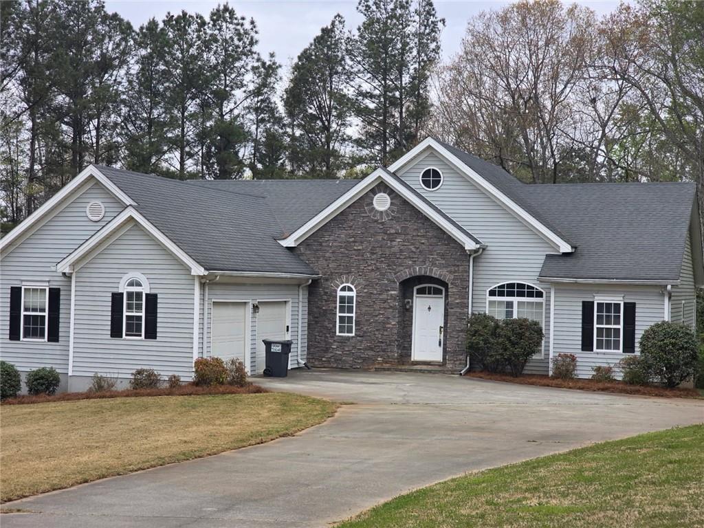 7387 Milam Road Winston, GA 30187 - Photo 2 of 41 a front view of a house with a yard and garage