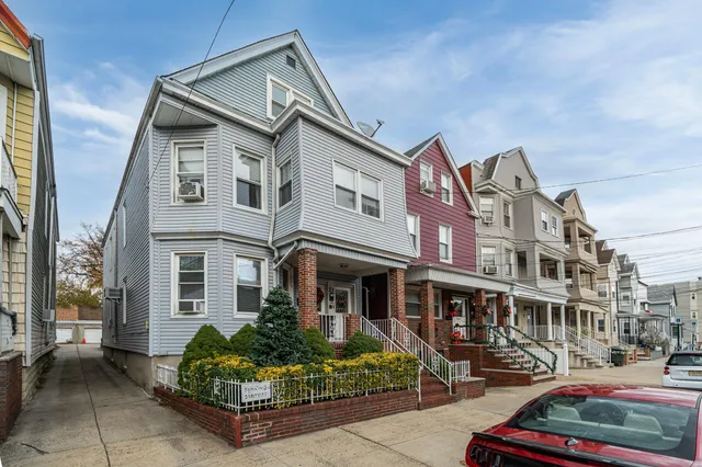 a front view of a residential apartment building with a yard