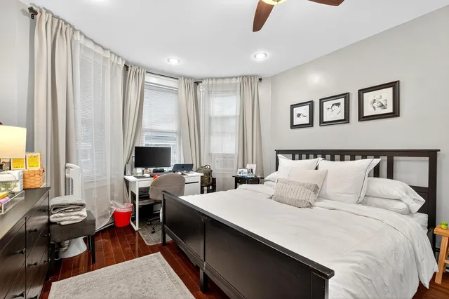 a bedroom with furniture and a large window