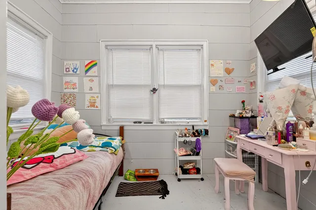 a bedroom with furniture a bed and a window