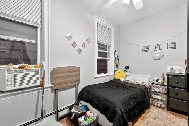 a bedroom with a bed and a window