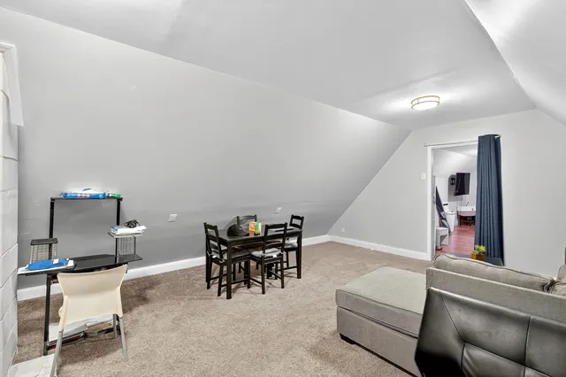 a living room with furniture a dining table and chairs