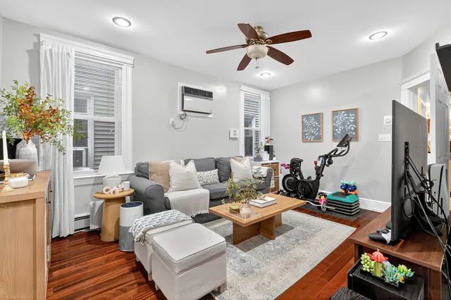 a living room with furniture ceiling fan and a window