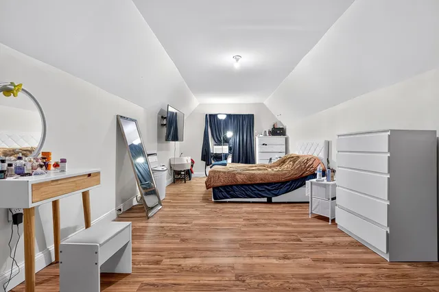 a bedroom with a bed and a dresser