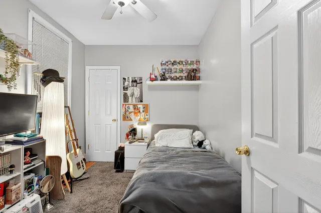 a bedroom with bed and a chandelier