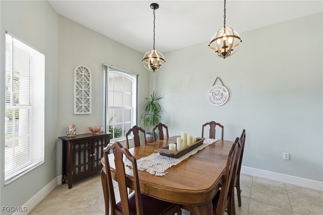 2412 Nature Pointe Loop Fort Myers, FL 33905 - Photo 13 of 44 a view of a dining room with furniture window and wooden floor