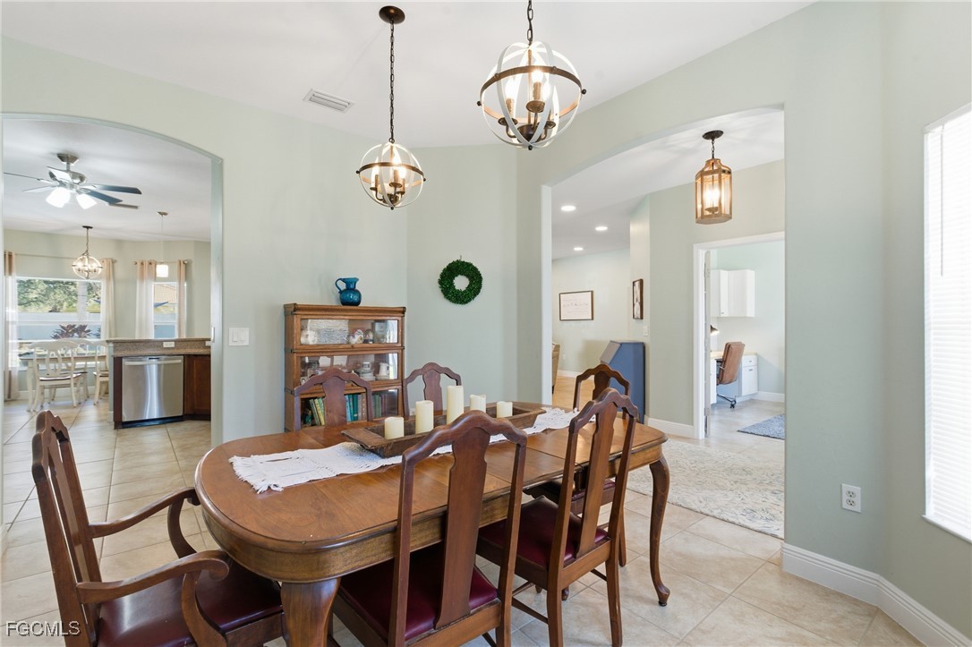 2412 Nature Pointe Loop Fort Myers, FL 33905 - Photo 14 of 44 a view of a dining room with furniture and chandelier