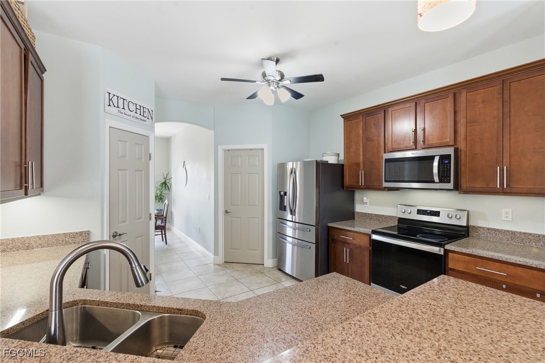 2412 Nature Pointe Loop Fort Myers, FL 33905 - Photo 16 of 44 a kitchen with refrigerator cabinets and stainless steel appliances