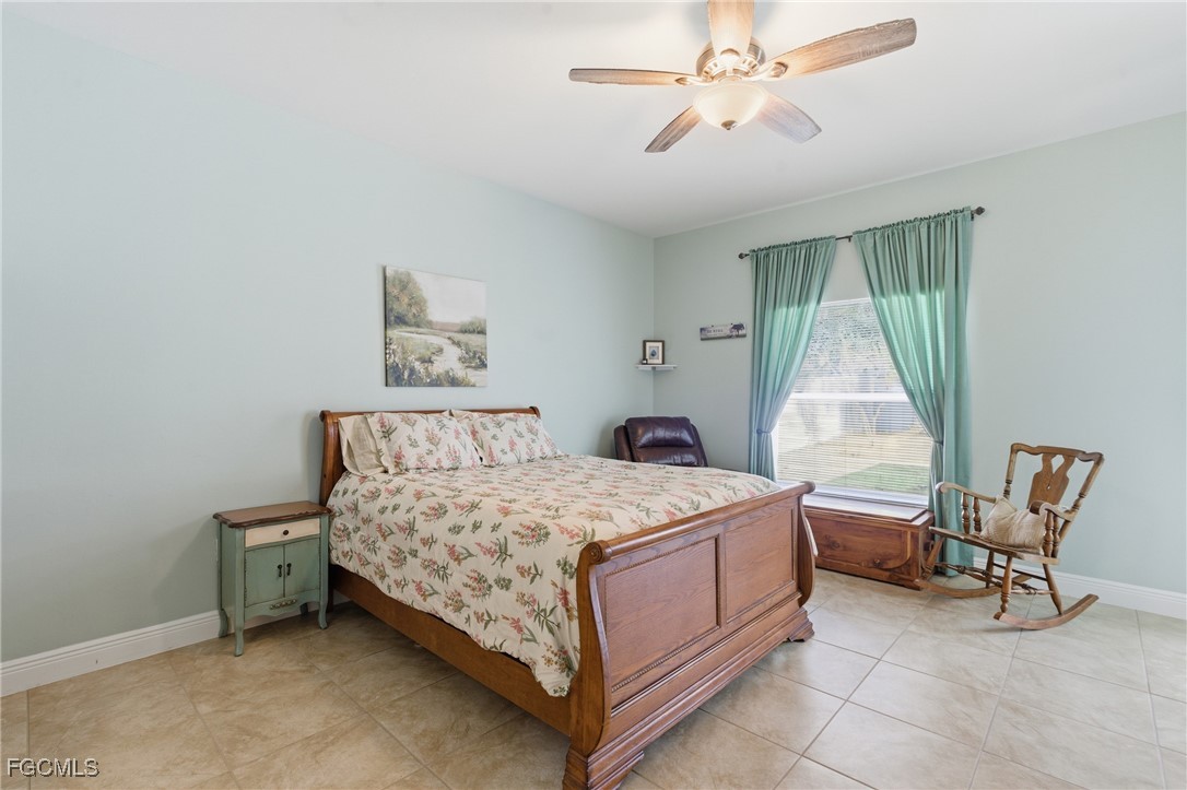 2412 Nature Pointe Loop Fort Myers, FL 33905 - Photo 24 of 44 a bedroom with a bed chair and window