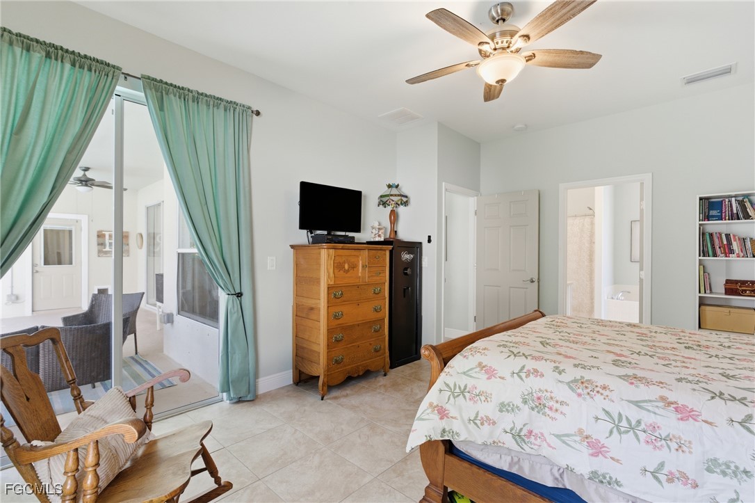 2412 Nature Pointe Loop Fort Myers, FL 33905 - Photo 27 of 44 a bedroom with a bed and a flat screen tv