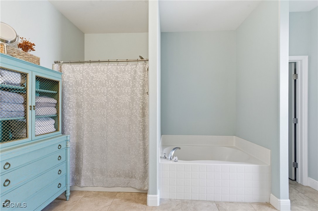 2412 Nature Pointe Loop Fort Myers, FL 33905 - Photo 28 of 44 a bathroom with a bathtub and a shower