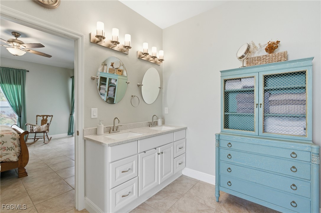 2412 Nature Pointe Loop Fort Myers, FL 33905 - Photo 29 of 44 a bathroom with a sink a vanity and a mirror