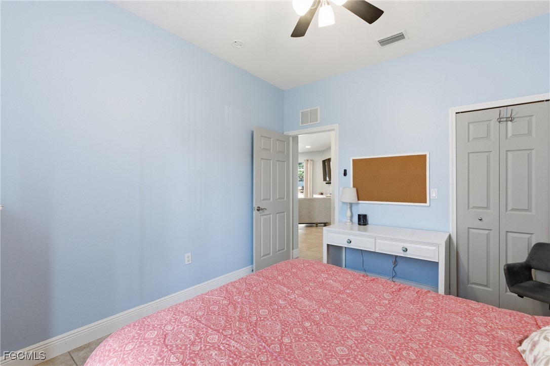 2412 Nature Pointe Loop Fort Myers, FL 33905 - Photo 31 of 44 a bedroom with a bed and a flat screen tv