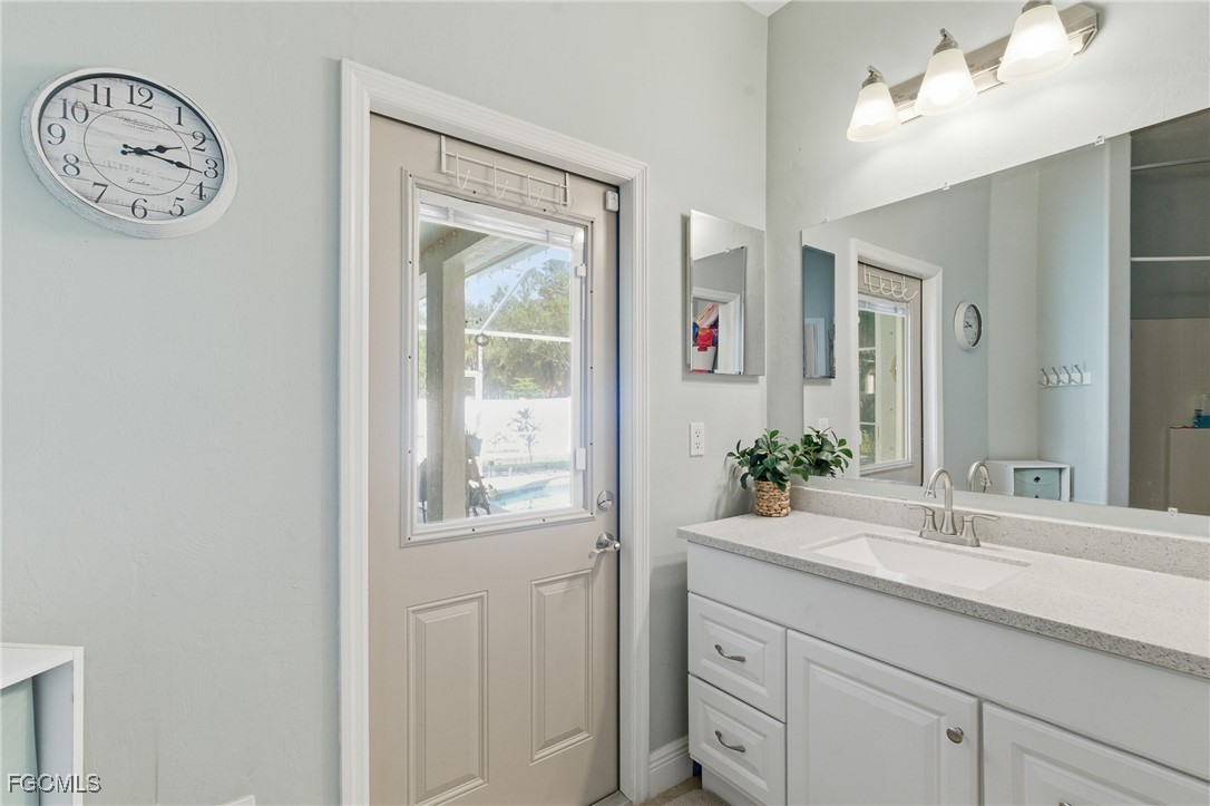 2412 Nature Pointe Loop Fort Myers, FL 33905 - Photo 32 of 44 a bathroom with a toilet a sink and a mirror
