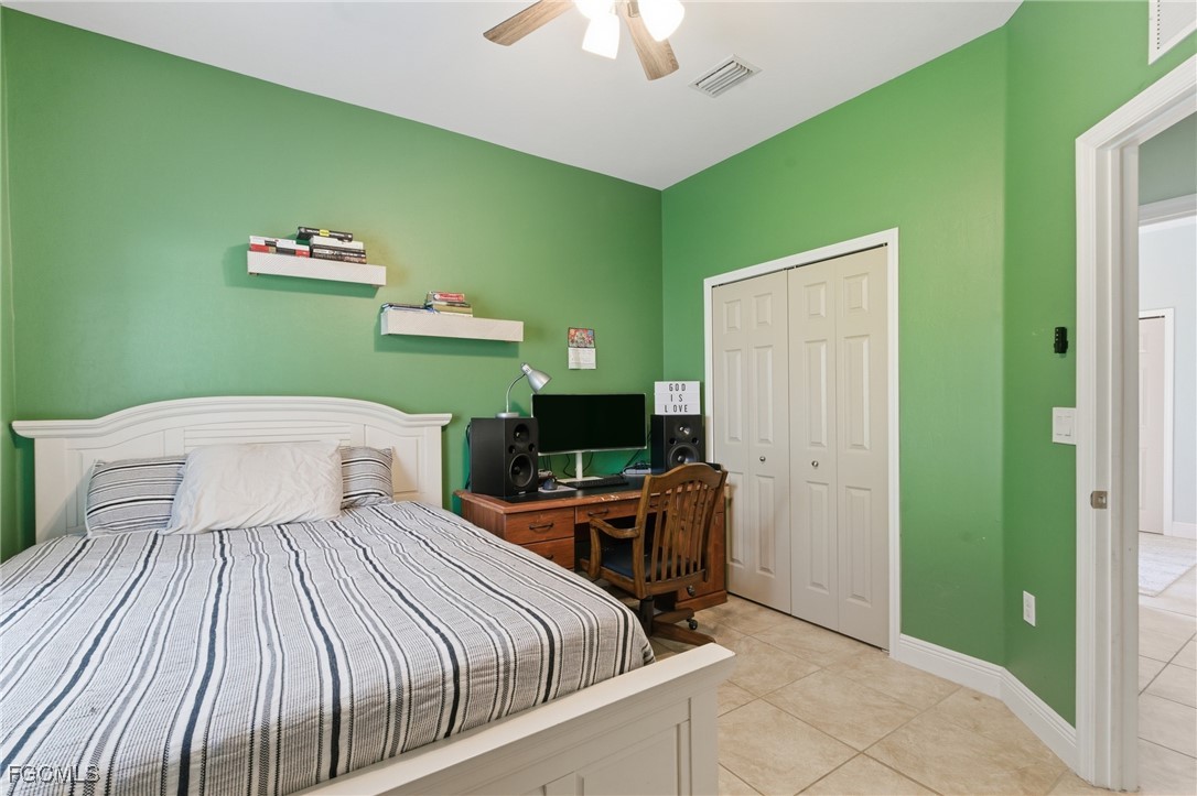 2412 Nature Pointe Loop Fort Myers, FL 33905 - Photo 35 of 44 a bedroom with a bed and a chandelier