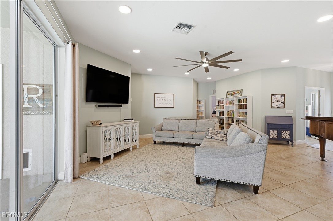2412 Nature Pointe Loop Fort Myers, FL 33905 - Photo 7 of 44 a living room with furniture and a flat screen tv