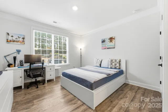 a bedroom with a bed and a desk