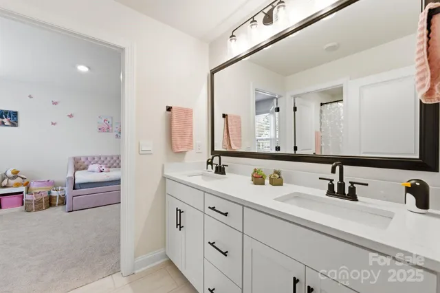 a bathroom with a double vanity sink and a mirror