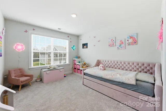 a bedroom with a bed and a couch