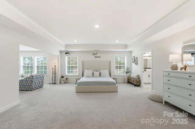 a spacious bedroom with a bed and a couch