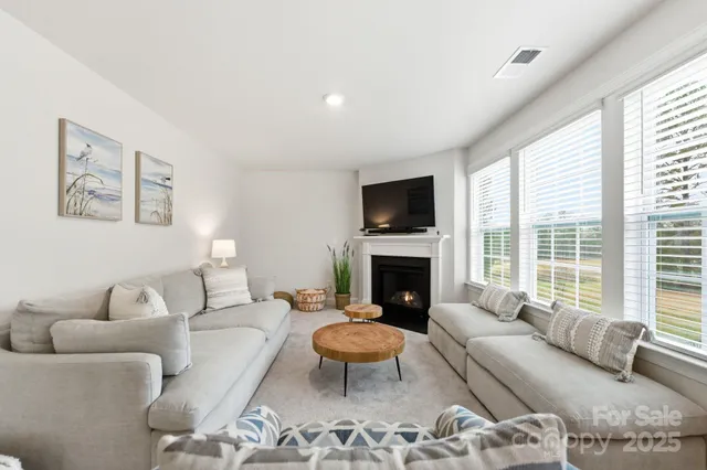 a living room with furniture a rug and a fireplace