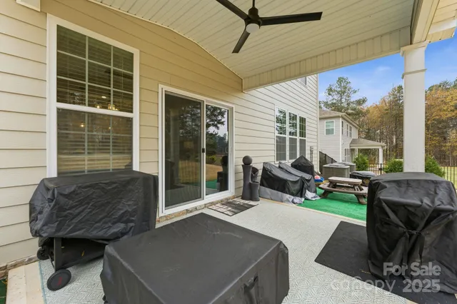 a view of house with backyard and outdoor seating