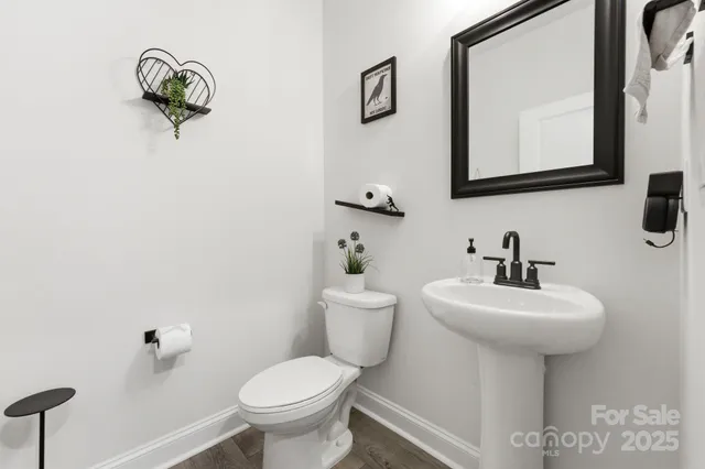 a bathroom with a toilet a sink and mirror