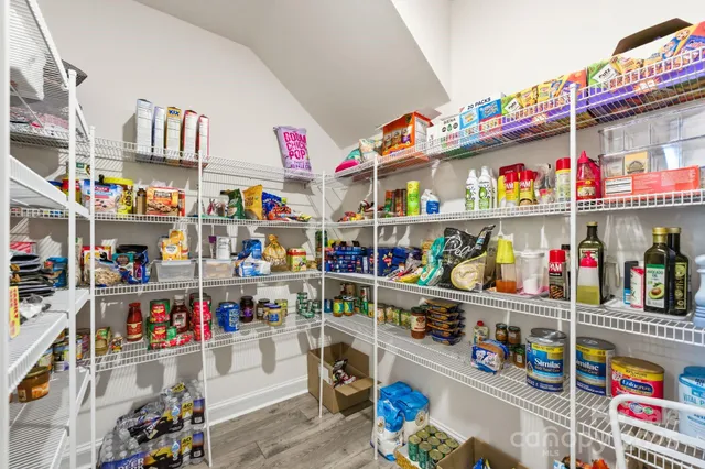 a store room with lots of clutter and refrigerator
