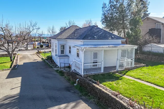 a front view of house with yard and green space