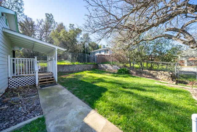 a view of a backyard with sitting area