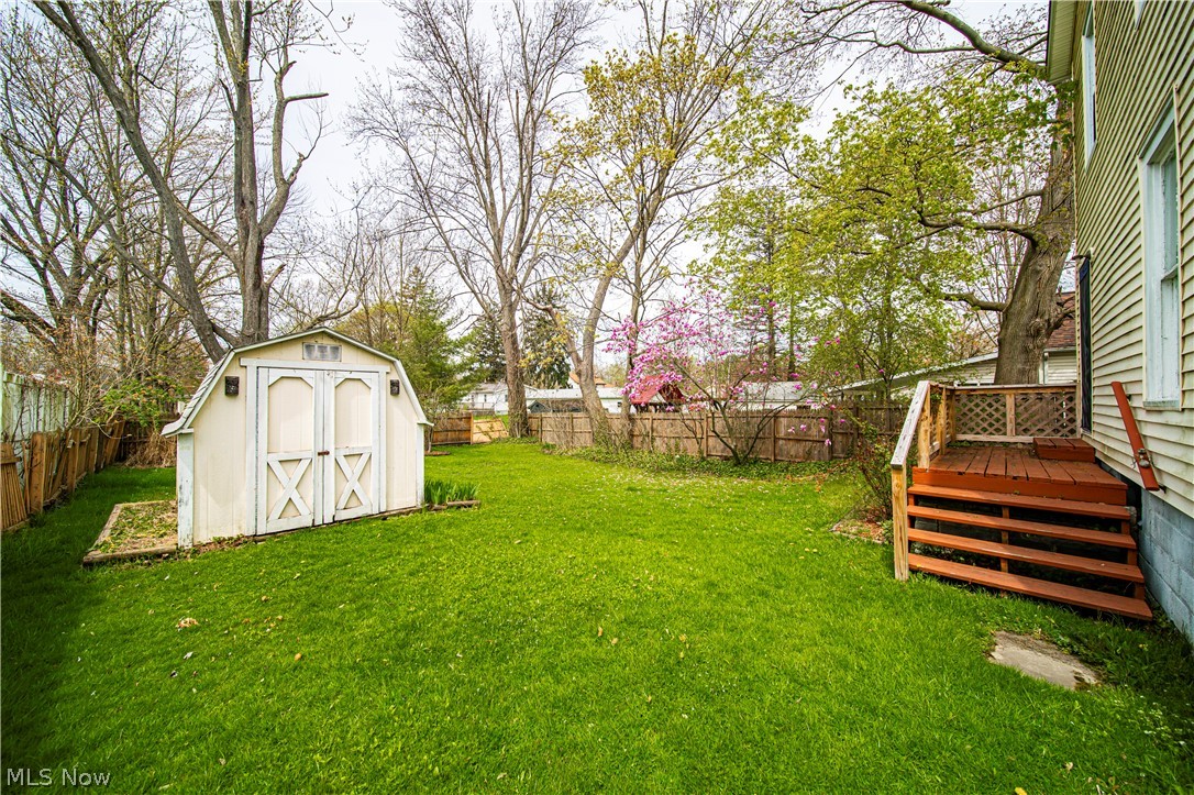 116 South Cedar Street Geneva, OH 44041 - Photo 29 of 35 View of yard with a wooden deck and a shed