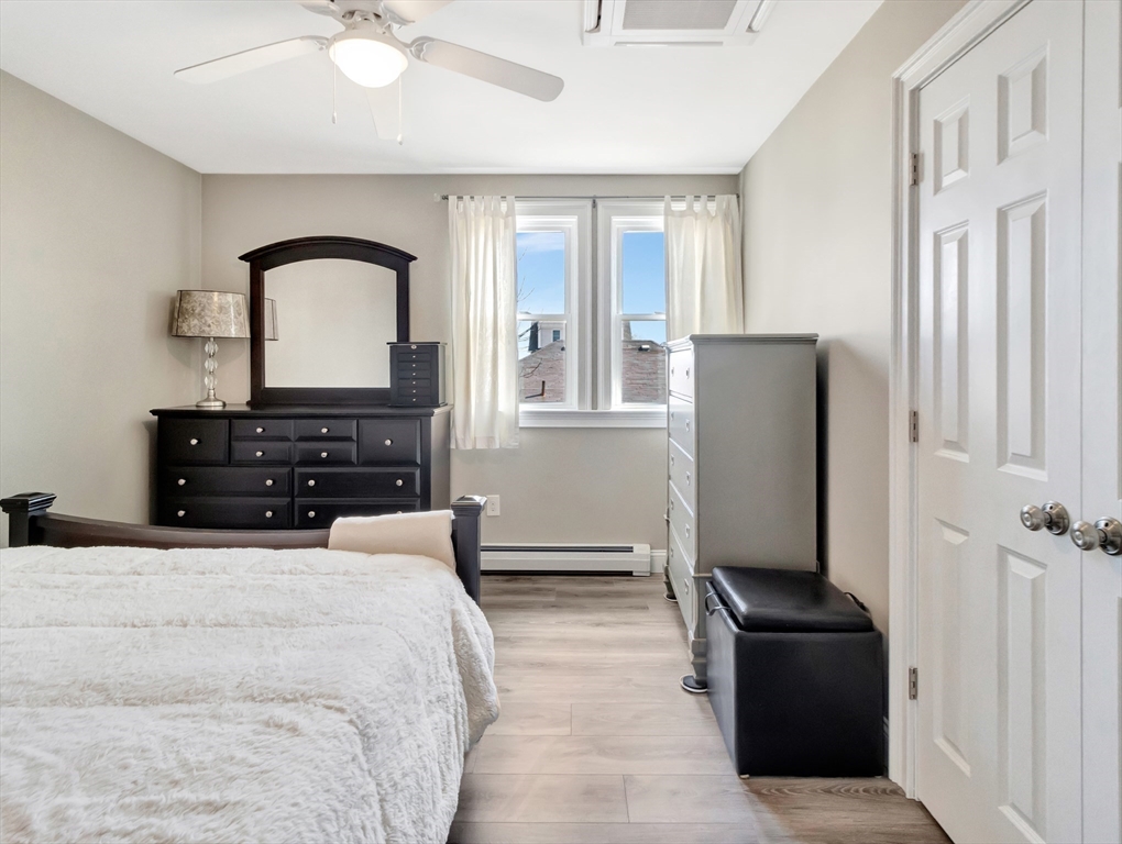 47 B Street, Unit BEACHSIDE Hull, MA 02045 - Photo 27 of 42 a bedroom with a bed dresser and a window