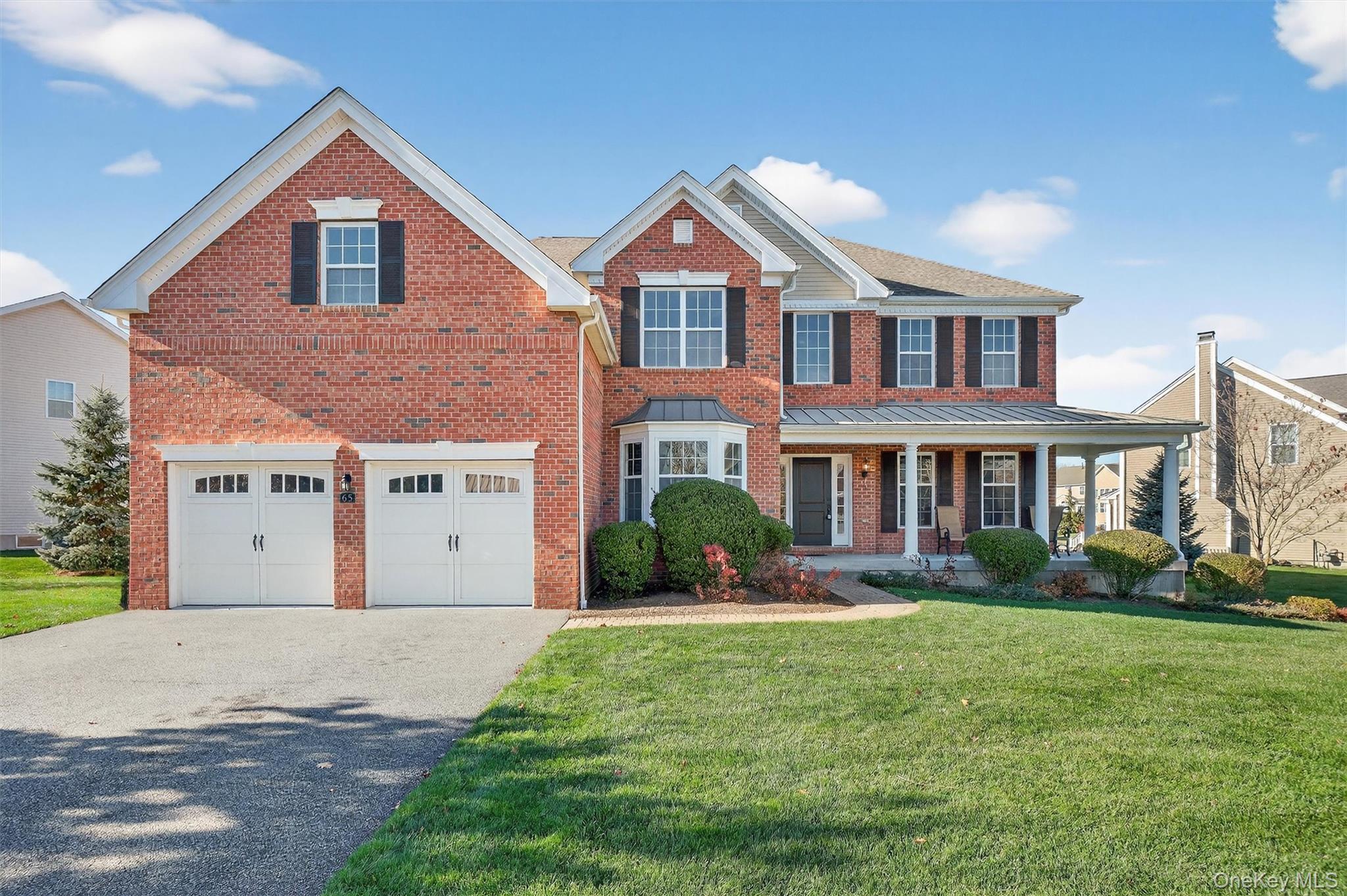 65 Fenton Way Hopewell Junction, NY 12533 - Photo 1 of 1 a front view of a house with a yard and garage
