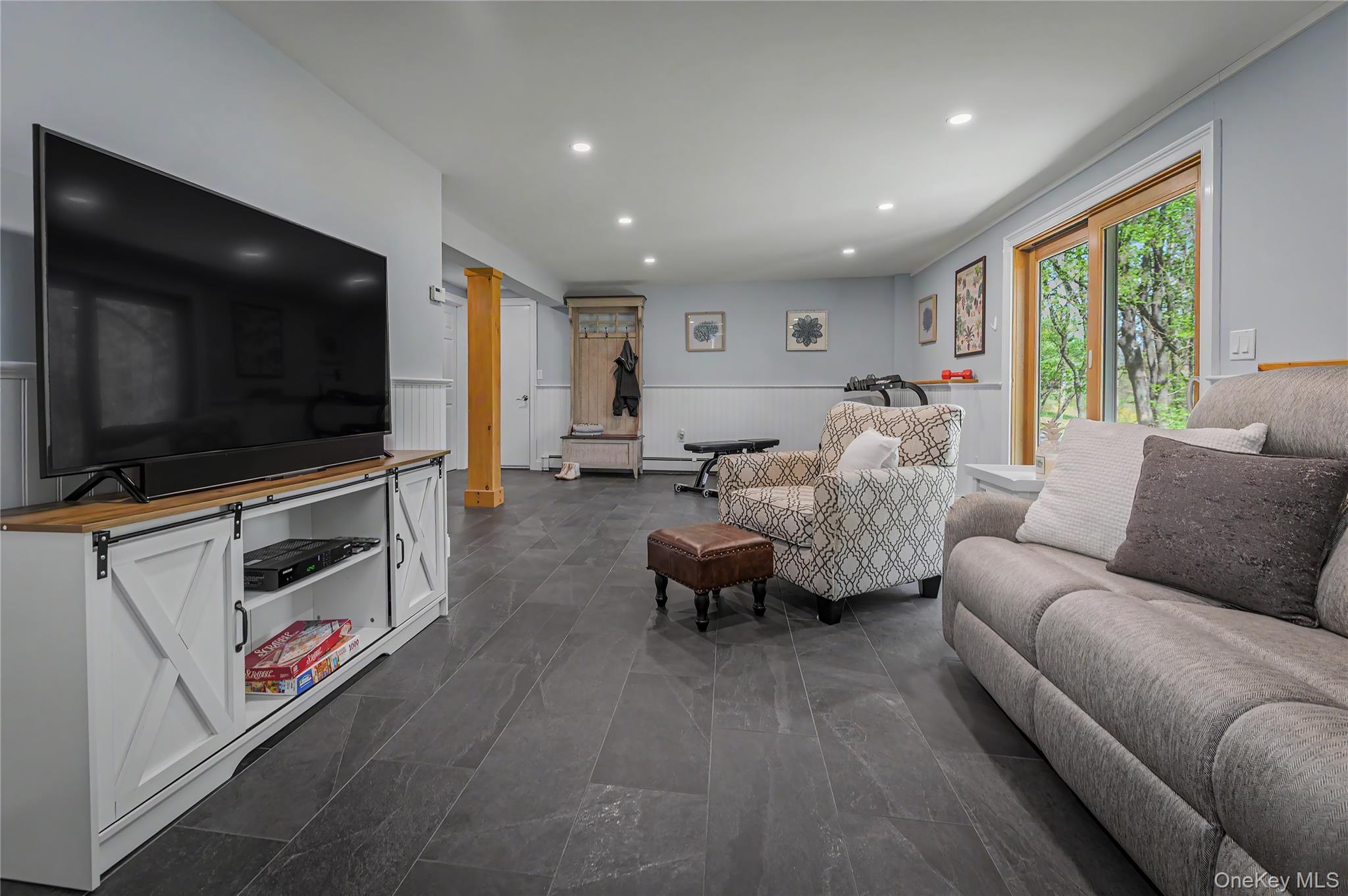 41 Cross Pond Road Pound Ridge, NY 10576 - Photo 34 of 41 a living room with furniture and a flat screen tv