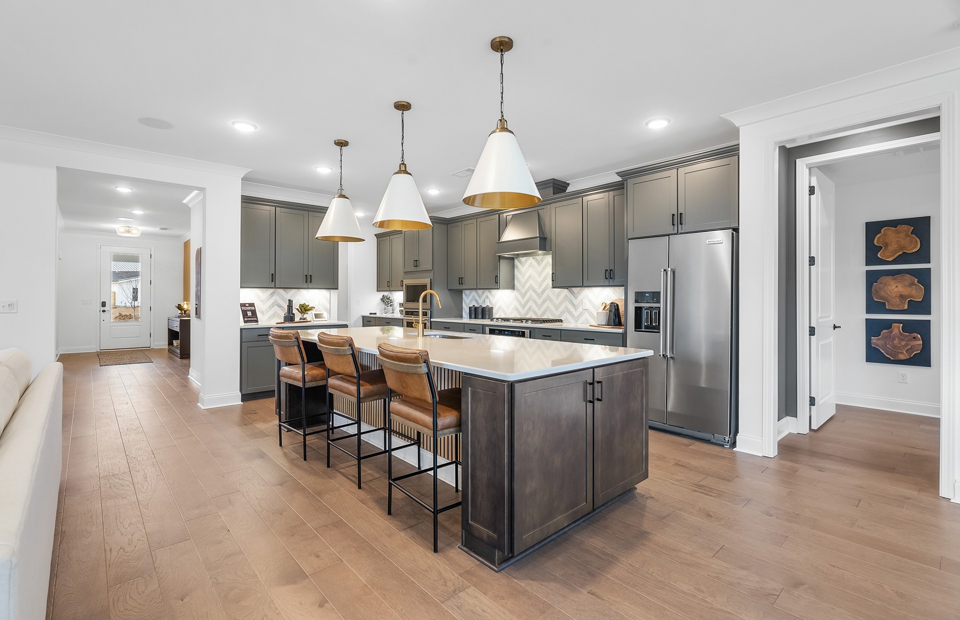 21 Pinnacles Lane Lebanon, TN 37090 - Photo 69 of 81 a kitchen with stainless steel appliances kitchen island granite countertop a refrigerator a sink a stove and a dining table with wooden floor
