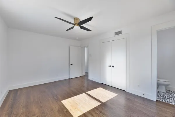 a view of a room with wooden floor and white walls