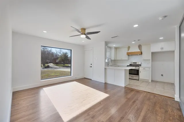 a view of kitchen with granite countertop cabinets stainless steel appliances with wooden floor