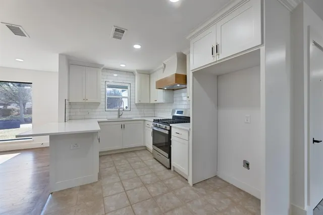 a kitchen with a stove top oven sink and cabinets