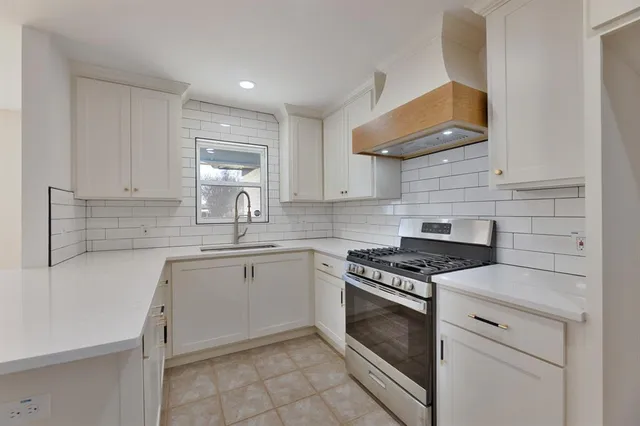 a kitchen with cabinets appliances and a sink