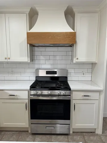 a stove top oven sitting inside of a kitchen